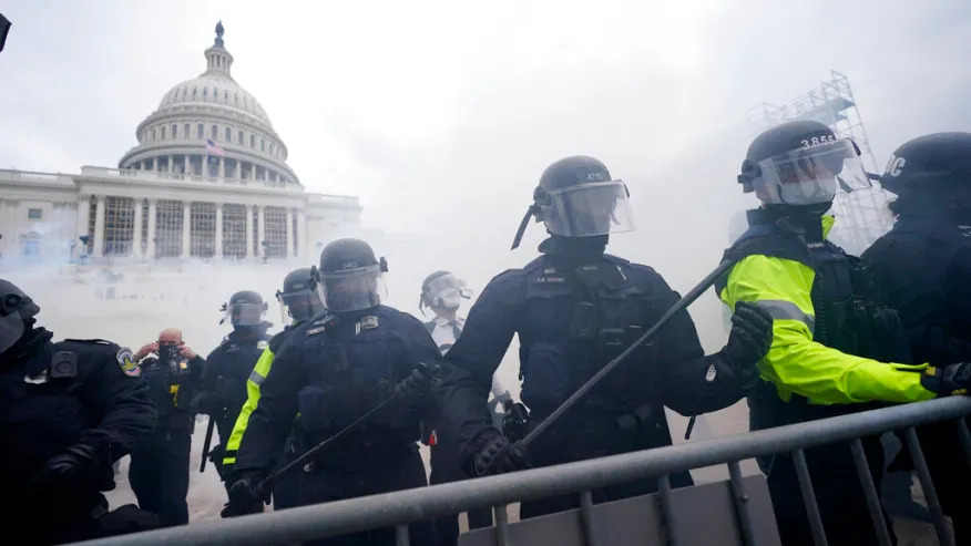 Police stand guard after holding off Trump supporters who tried to break through a police barrier, Wednesday, Jan. 6, 2021, (AP Photo/Julio Cortez)