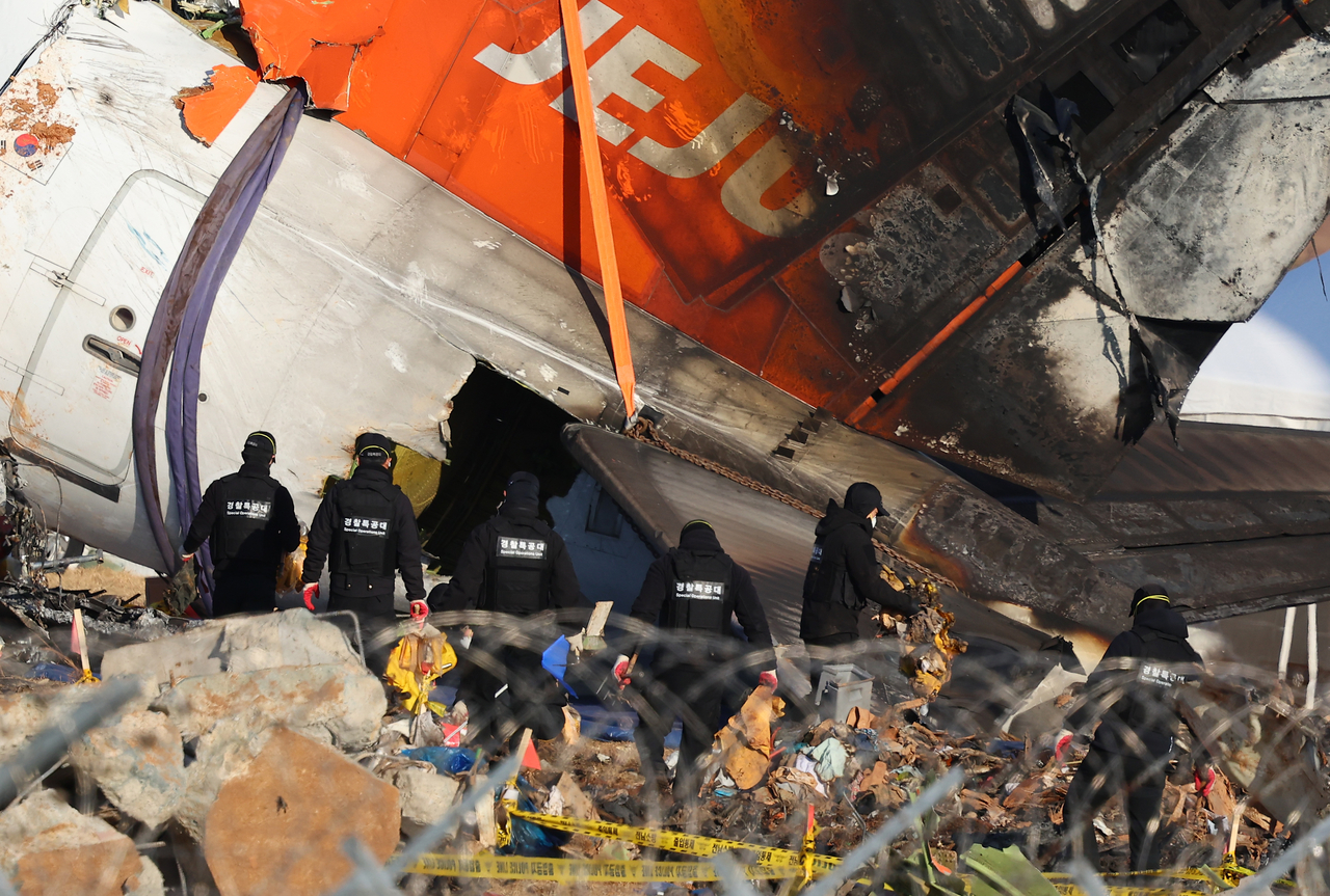 Search operations are under way by police officers near Muan International Airport, southwestern South Korea, on Jan. 4, following the crash of a Jeju Air passenger plane that killed all but two of 181 people on Dec. 29, 2024. (Yonhap)