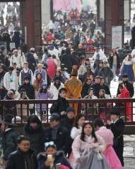Palace filled with hanbok-clad visitors