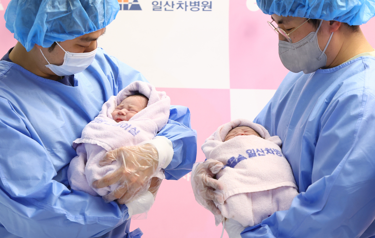 Fathers cradle South Korea’s first newborns of 2025 at Cha Ilsan Medical Center in Goyang, Gyeonggi Province, shortly after midnight on New Year’s Day. (Newsis)