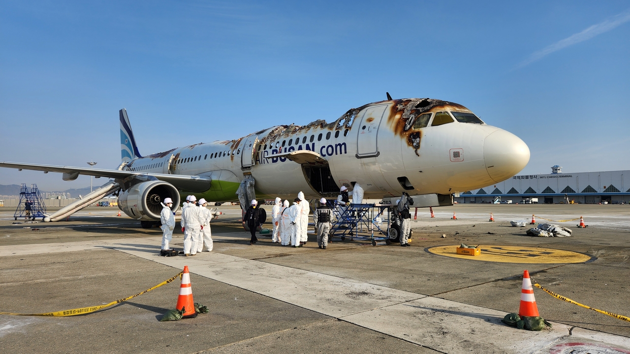 A joint investigation team and France's Bureau of Enquiry and Analysis for Civil Aviation Safety conduct an on-site safety inspection of the Air Busan aircraft that caught fire on Jan. 30. (Ministry of Land, Infrastructure and Transport)