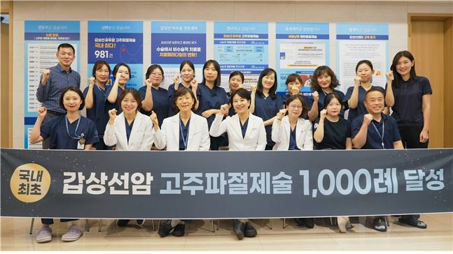 Baek Sun-mi (third from left in the front), director of Haeundae Sharing and Happiness Hospital, and other medical staff at the hospital's Thyroid Center pose during a ceremony to commemorate achieving 1,000 cases of radiofrequency ablation for thyroid cancer. (Haeundae Sharing and Happiness Hospital)