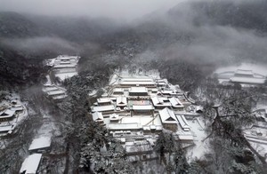 Snow-covered hills, streets, temples form picturesque scenes