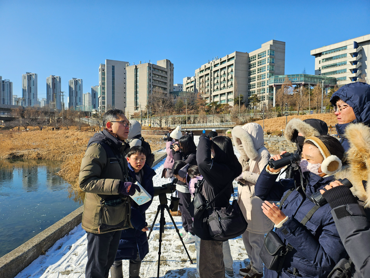 지난 8일 서울 성동구 중랑천에서 진행된 버드쓰담 활동에 참여한 탐조객들이 철새를 보고 있다. 김광우 기자.