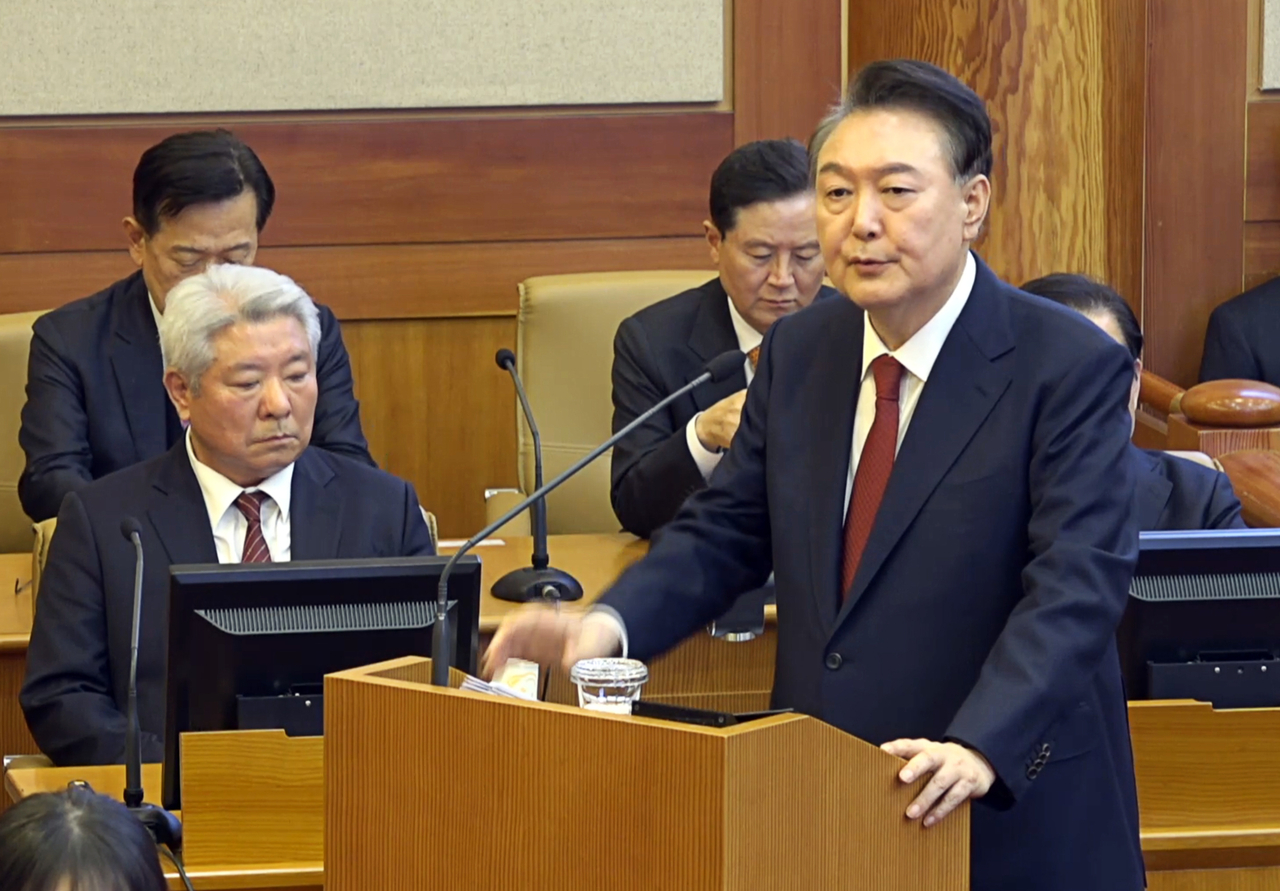 President Yoon Suk Yeol stands before a podium to deliver his final defense at the Constitutional Court hearing on Tuesday. Yonhap
