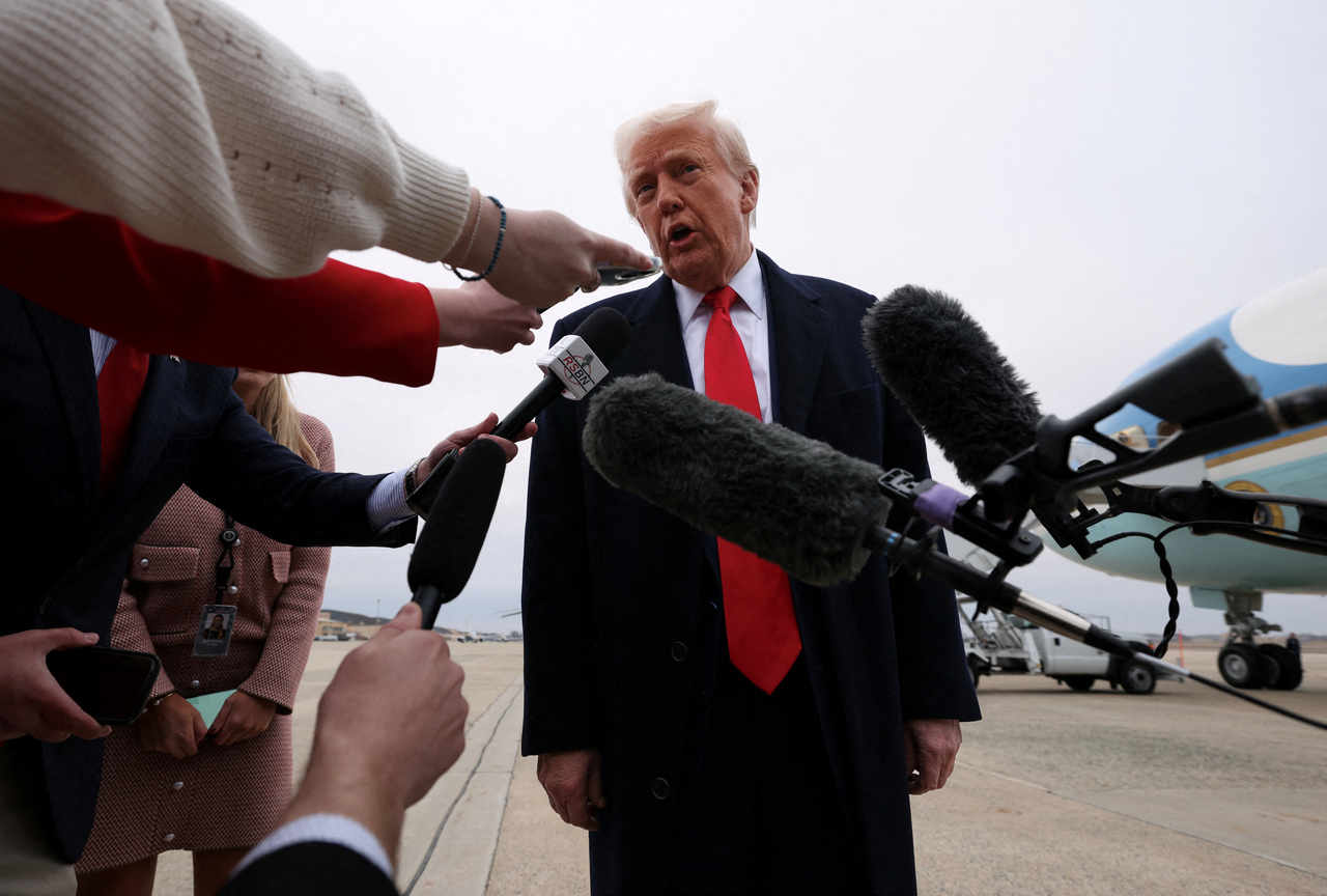 US President Donald Trump speaks to reporters before boarding Air Force One as he departs from Joint Base Andrews in Maryland, Friday. (Reuters-Yonhap)