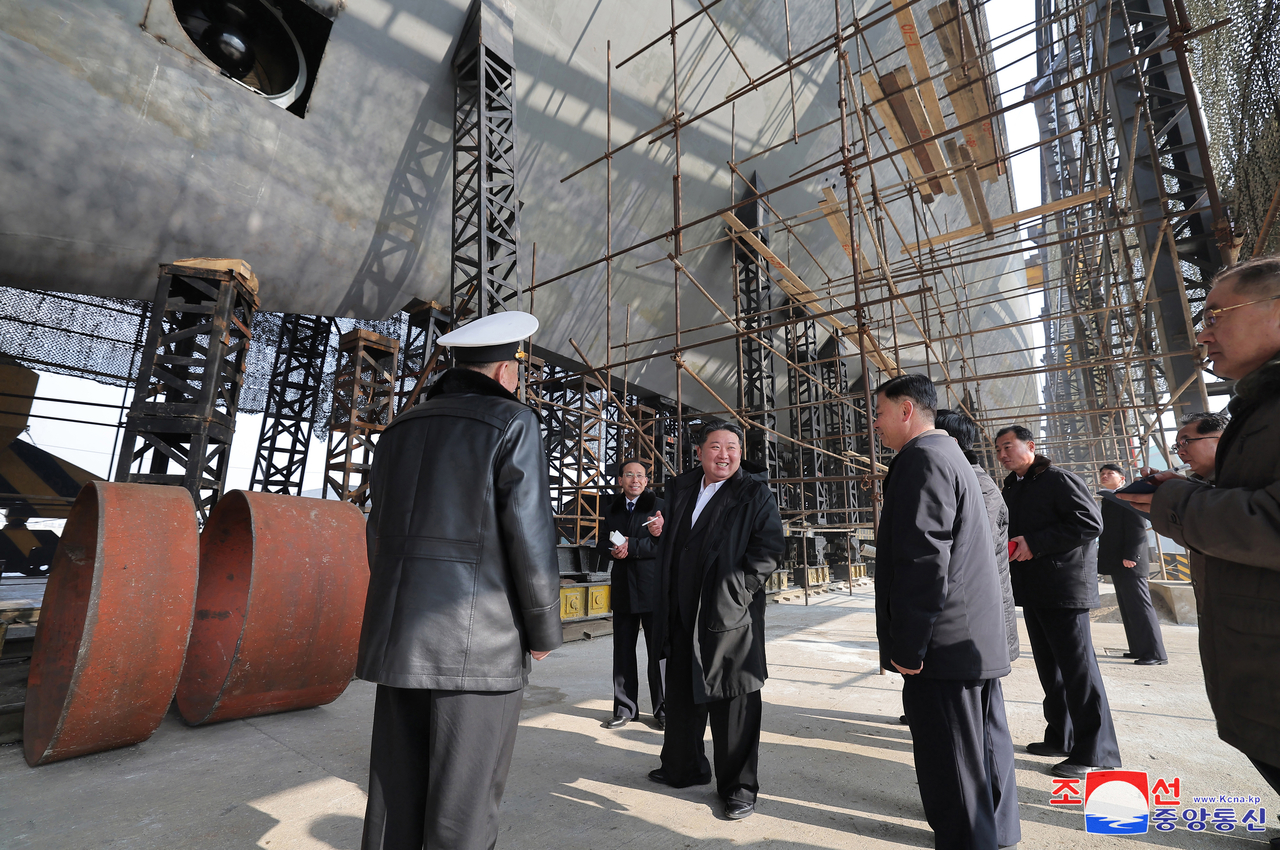 Kim Jong-un visiting a major shipyard to inspect the progress of building a nuclear-powered submarine on Mar.8. (KCNA)