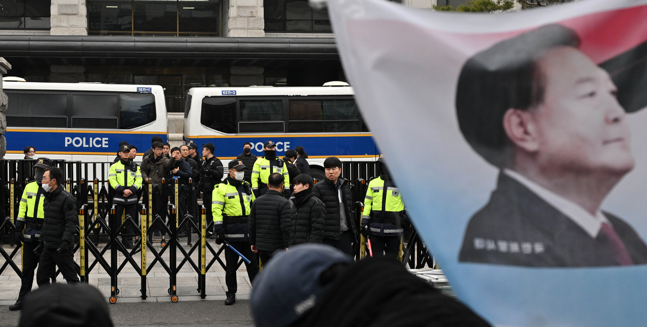 A flag with the face of suspended President Yoon Suk Yeol is being waved in front of the Constitutional Court in Jongno-gu, Seoul on March 12. (Im Se-jun / The Korea Herald)