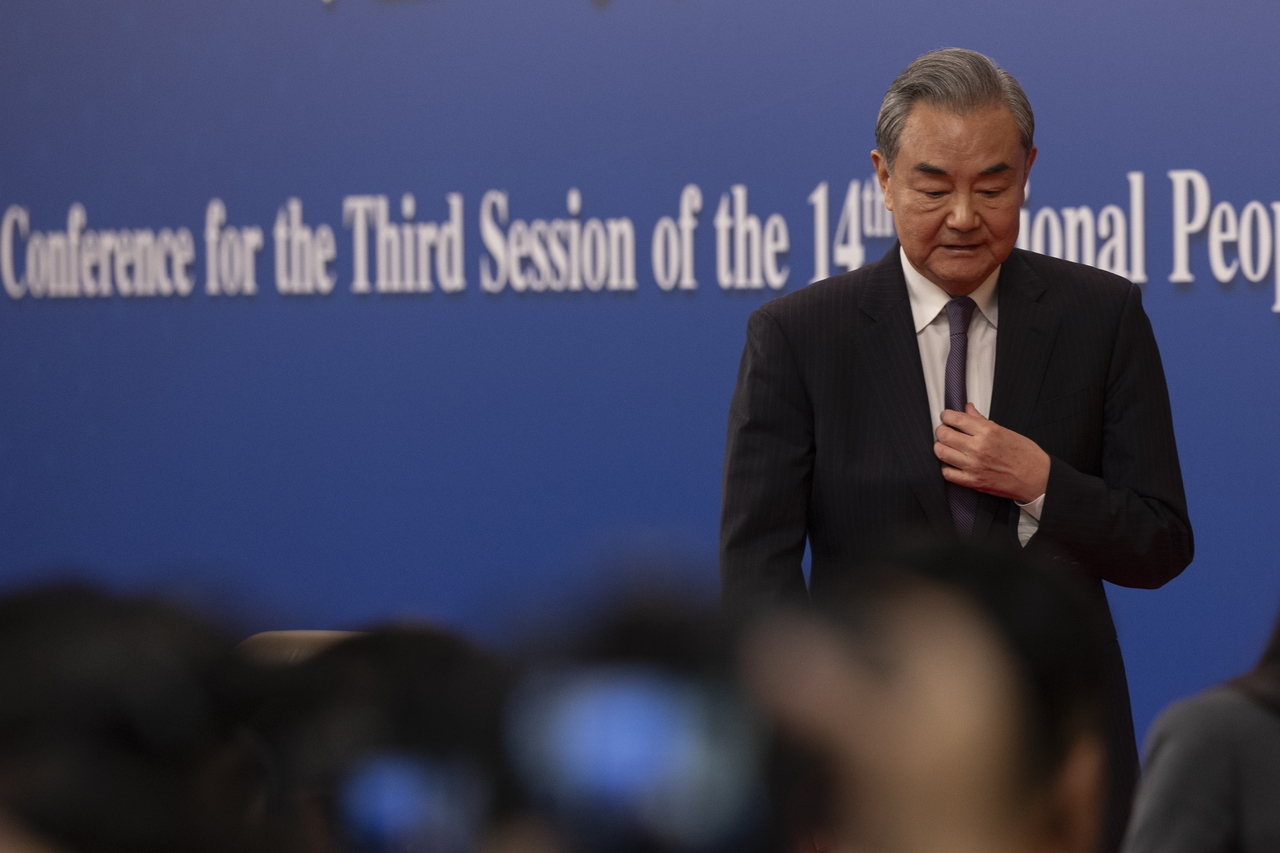 China's Foreign Minister Wang Yi (center) leaves after a press conference about foreign policy and external relations for the Third Session of the 14th National People's Congress of China in Beijing on March 7. (EPA)