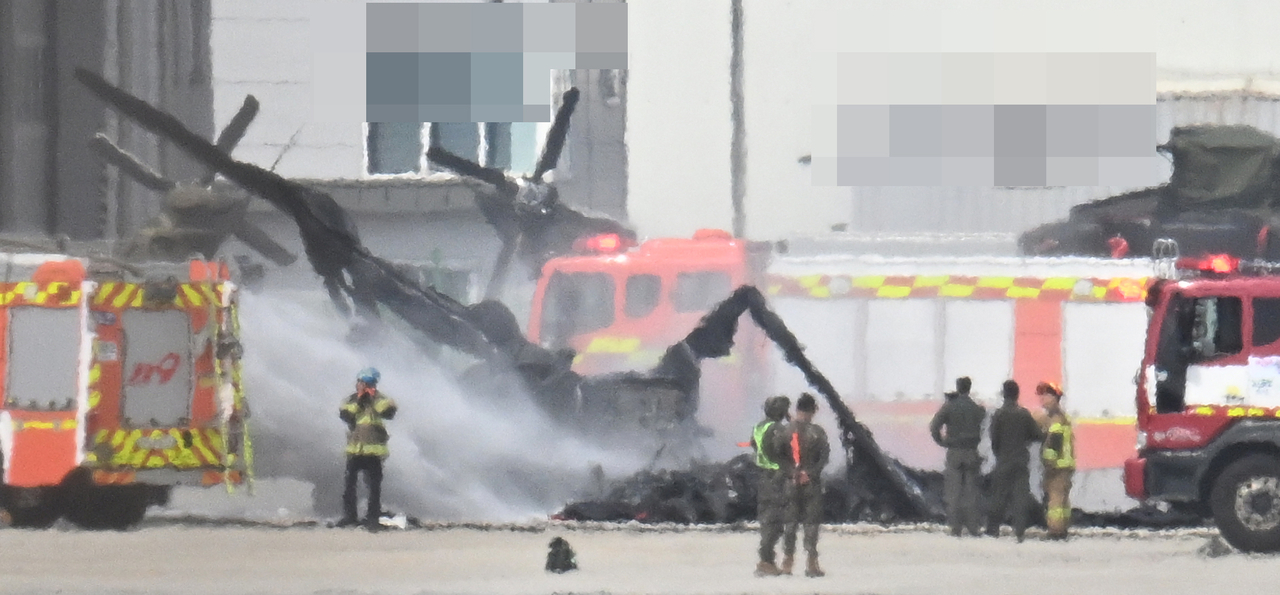 Smoke billows from a destroyed KUH-1 helicopter after an Army drone crashed into it on the airfield of an Army base in Yangju, Gyeonggi Province on Monday. Yonhap