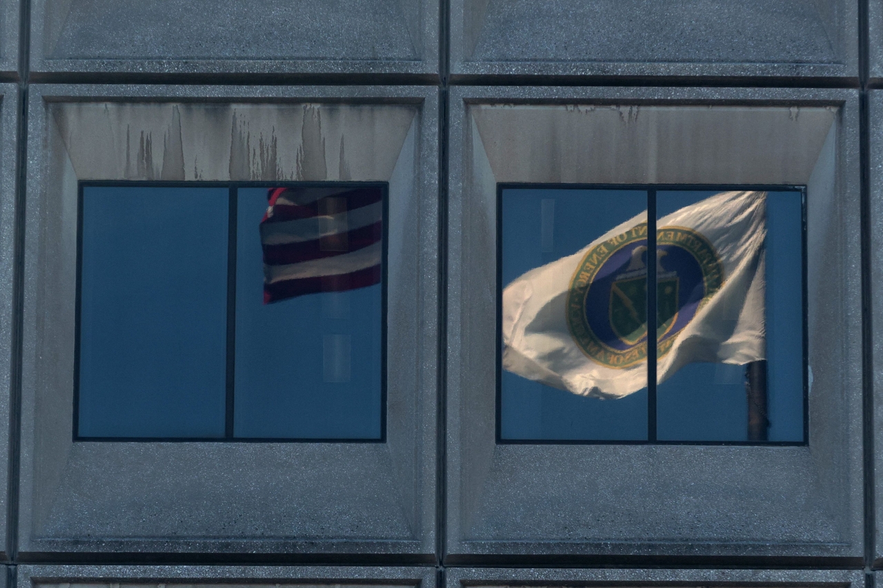 The reflection the flag of the U.S. Department of Energy is seen on its building on March 18, 2025 in Washington, DC. (Getty Images via AFP)