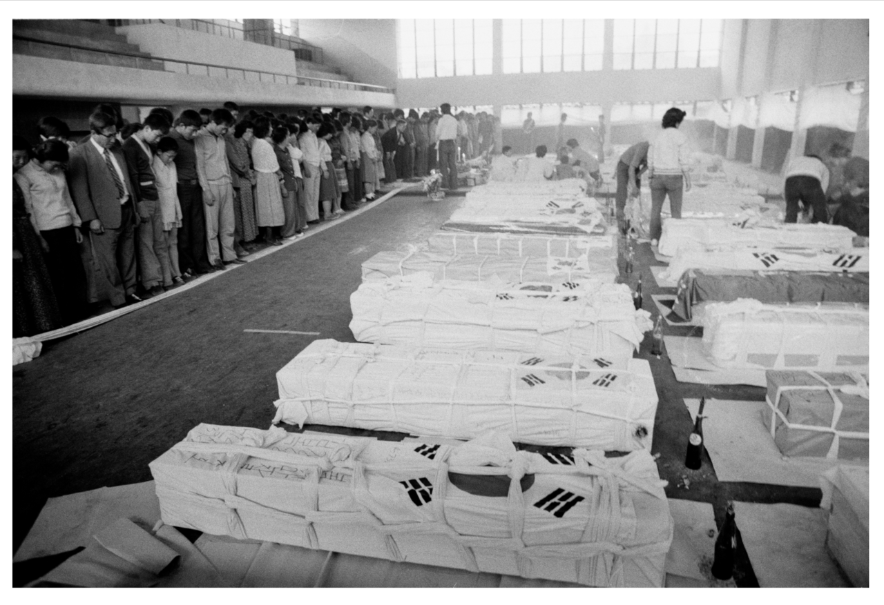 Coffins holding the victims of the Gwangju Democratic Uprising are placed inside Sangmugwan Hall in this photo taken on May 23, 1980. Previously, the hall served as a gymnasium for police officers under the Jeollanam-do Provincial Police Agency. It is also one of the key settings in Han Kang's novel "Human Acts," which vividly portrays the tragic events of the uprising. (5.18 Archives)