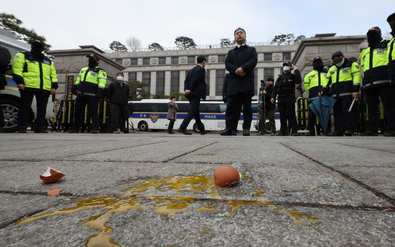 Eggs are seen on the ground near the Constitutional Court, in Seoul, after an identified person threw raw eggs at members of the Democratic Party of Korea on Thursday. (Yonhap)