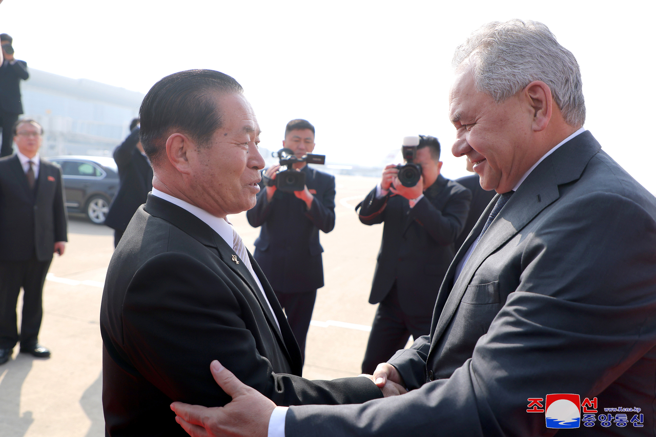 Pak Jong-chon (left), vice-chair of the Central Military Commission of the Workers’ Party of Korea, greets Russian Security Council Secretary Sergei Shoigu at Pyongyang International Airport on Friday (KNCA)