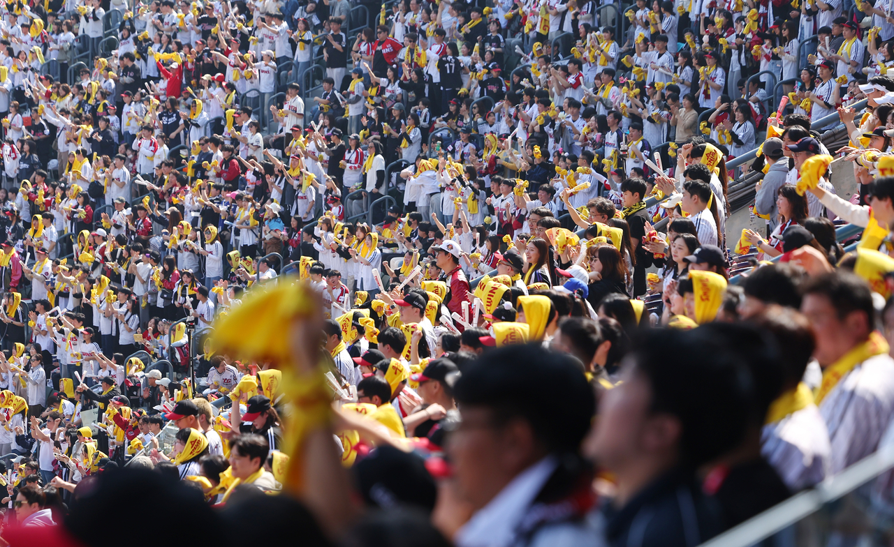 LG Twins fans rally behind their team during the 2025 KBO League season opener against the Lotte Giants at Jamsil Baseball Stadium in Seoul on Saturday. (Yonhap)