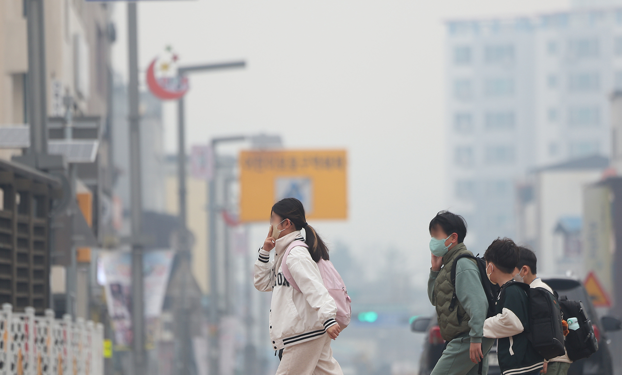 Students are seen wearing masks while heading to school in Uiseong-gun, North Gyeongsang Province, on Monday. (Yonhap)