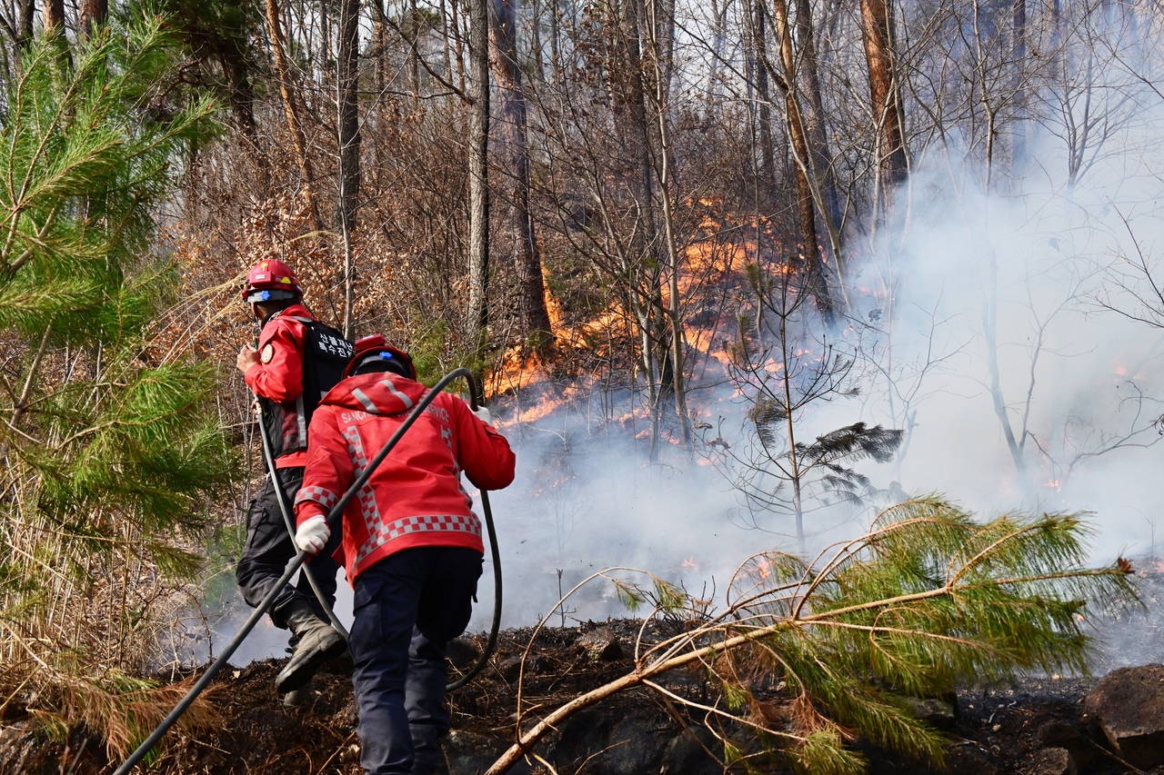 Wildfire response crews continue containment efforts in Sancheong County on Monday, the fourth day of a large-scale forest fire in South Gyeongsang Province. (Newsis)