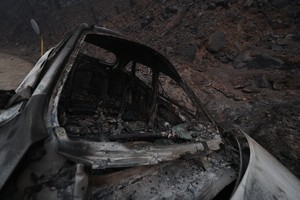 Among wildfire victims, a village chief and family who'd returned to evacuate villagers