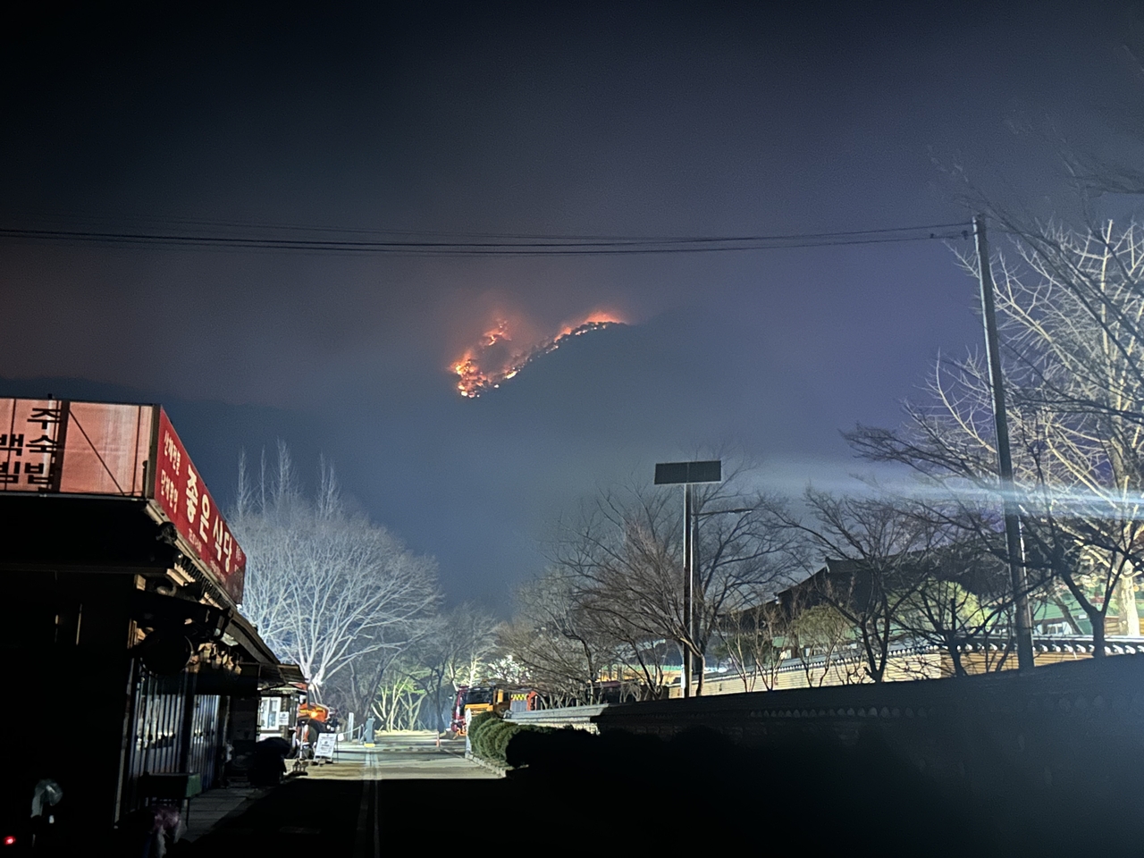 Flames are seen at a distance from Daejeonsa Temple in Cheongsong-gun, North Gyeongsang Province, in the wee hours of Thursday. (Yonhap)