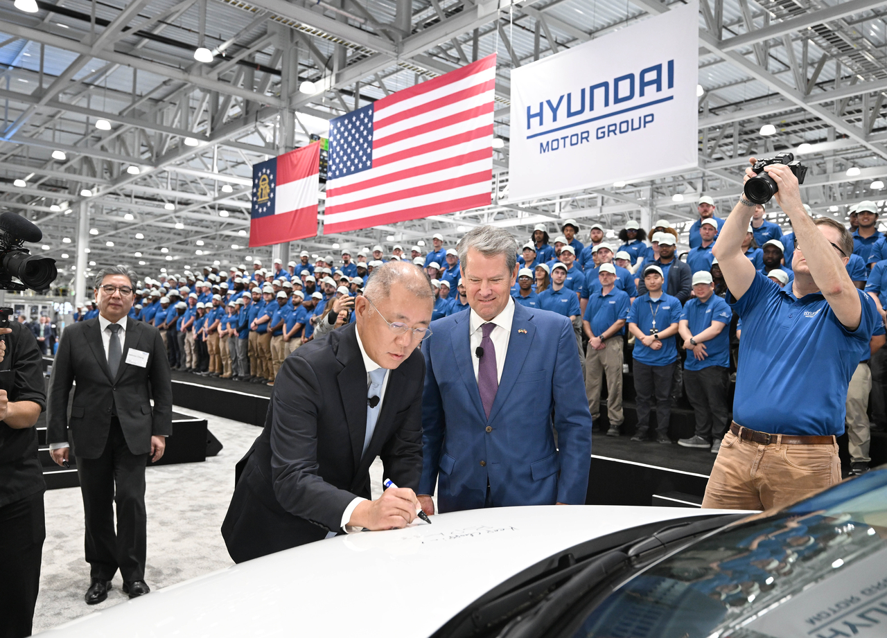 Hyundai Motor Group Executive Chair Chung Euisun autographs the hood of an Ioniq 5 during the opening ceremony of Hyundai Motor Group Metaplant America in Ellabell, Georgia, on Wednesday. (Hyundai Motor Group)