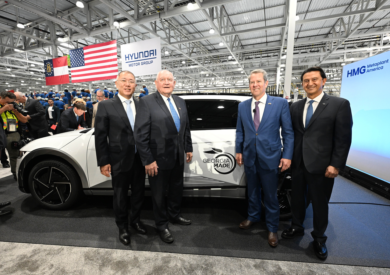 From left: Hyundai Motor Group Executive Chair Chung Euisun, former Georgia Gov. Sonny Perdue, Georgia Gov. Brian Kemp and Hyundai Motor Co. CEO Jose Munoz pose for a photo in front a Hyundai Ioniq 5 at the opening ceremony of Hyundai Motor Group Metaplant America in Ellabell, Georgia, Wednesday. (Hyundai Motor Group)