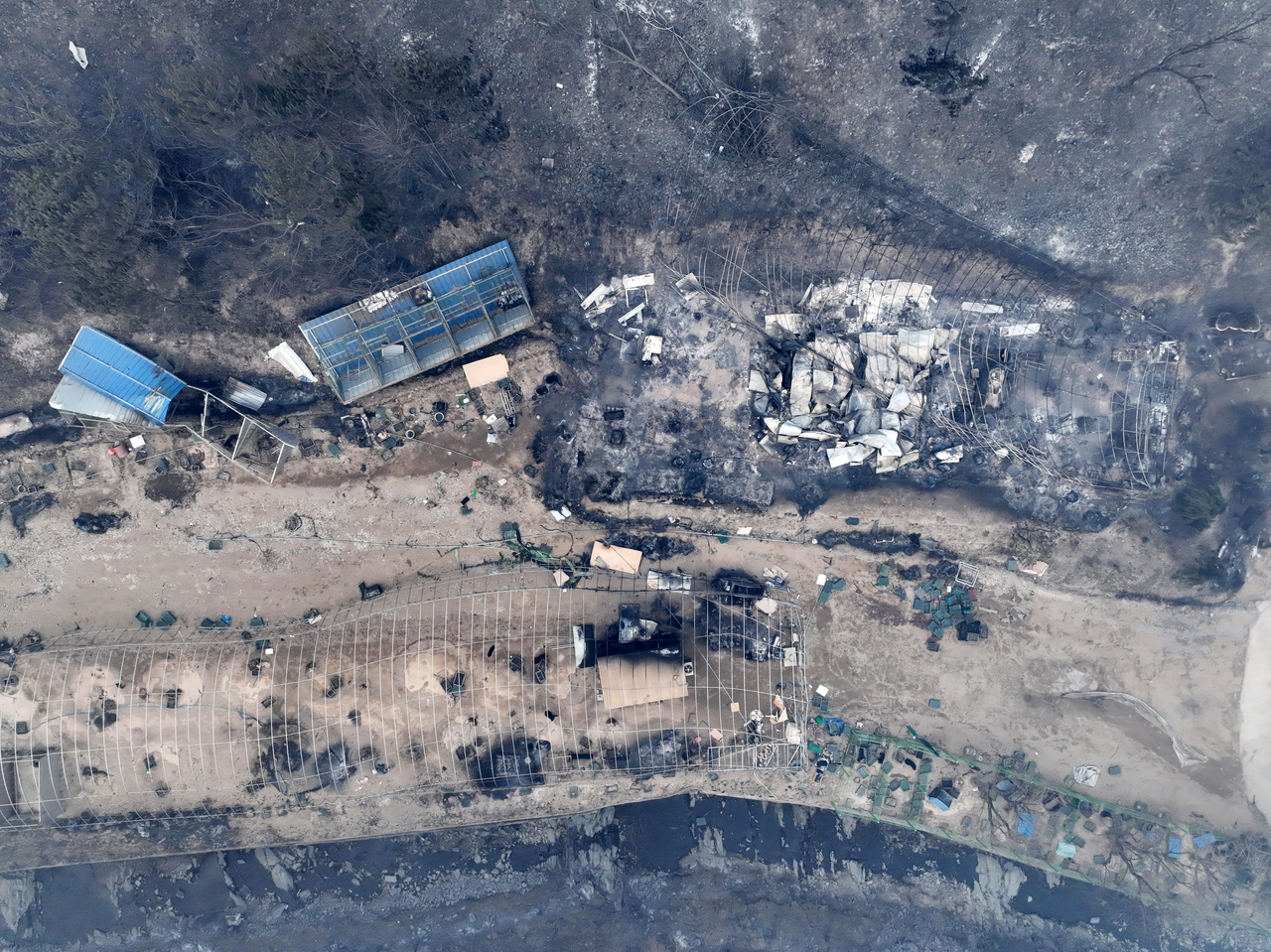 This photo, taken Wednesday, shows burnt-out houses in a destroyed village in Andong, North Gyeongsang Province, southeastern South Korea, after it was engulfed by a wildfire the previous day. (Yonhap)