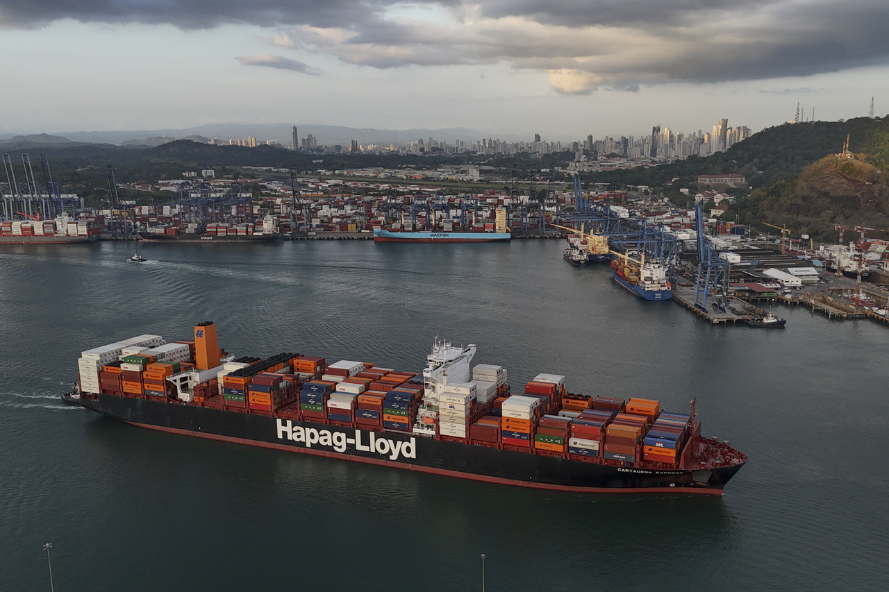 A cargo ship sails past the Panama Canal‘s Port of Balboa, managed by CK Hutchison Holdings, in Panama City, Thursday, March 13, 2025. (AP Photo/Matias Delacroix)