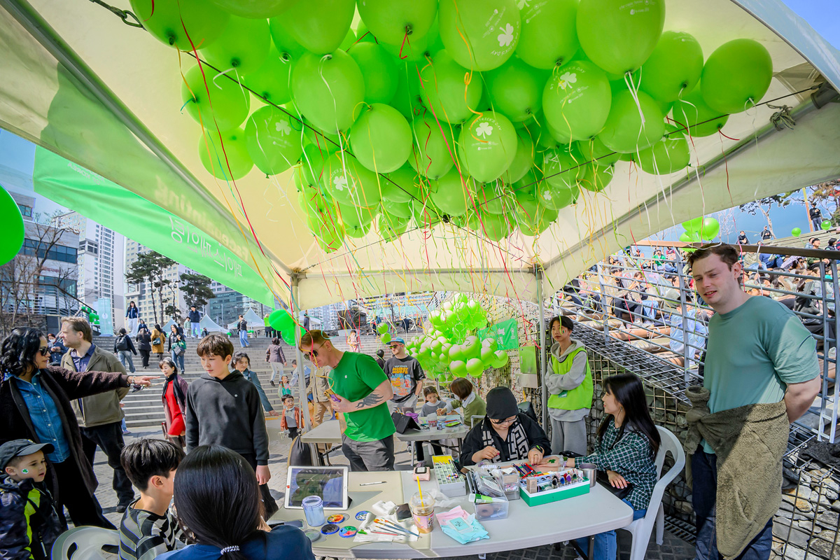 People celebrate St. Patrick's Day at D-Cube City Plaza outside Sindorim Station in Seoul on March 16, 2024. (Credit: Tom Coyner)