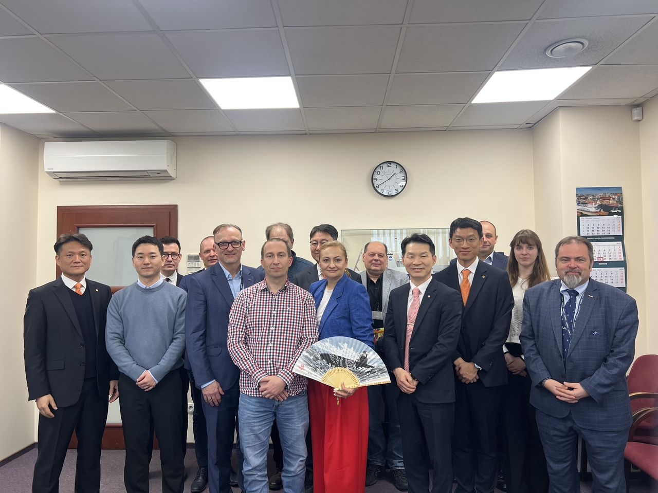 Hanwha Ocean employees, along with executives and staff from Nauta Shiprepair Yard, including Monika Kozakiewicz (fifth from left) pose for a photo on Tuesday at Nauta Shiprepair Yard headquarters in Gdynia, Poland. (Hanwha Ocean)