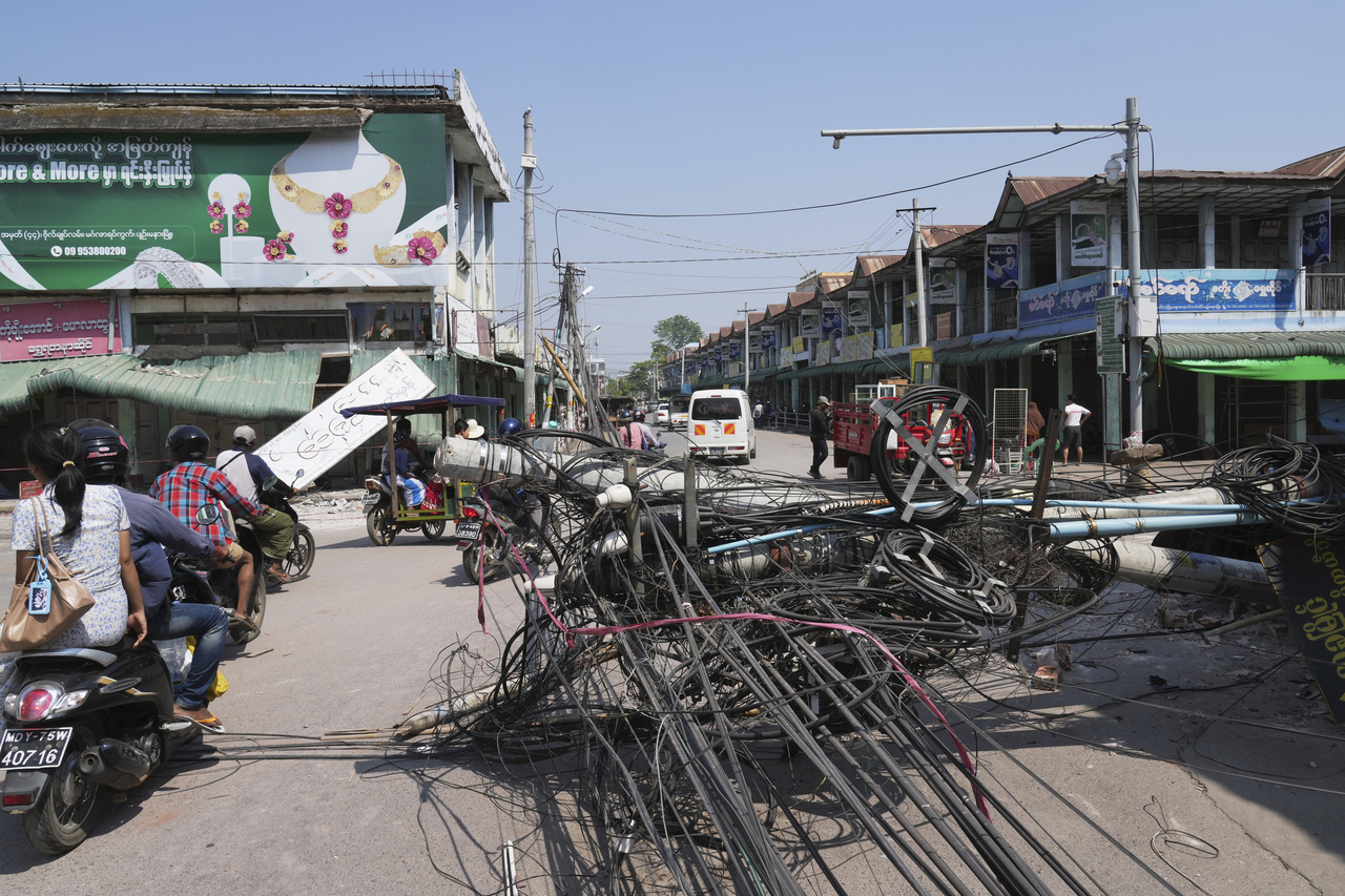 Local people ride their motorbikes past debris and damaged buildings, in the aftermath of an earthquake, in Naypyitaw, Myanmar, Sunday. (AP-Yonhap)