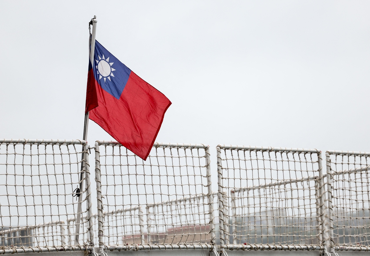 A Taiwan flag is seen at a harbor in Keelung, Taiwan, on Tuesday. China sent its army, navy, air and rocket forces to surround Taiwan for drills Beijing said were aimed at practicing a blockade of the self-ruled island. (AFP)