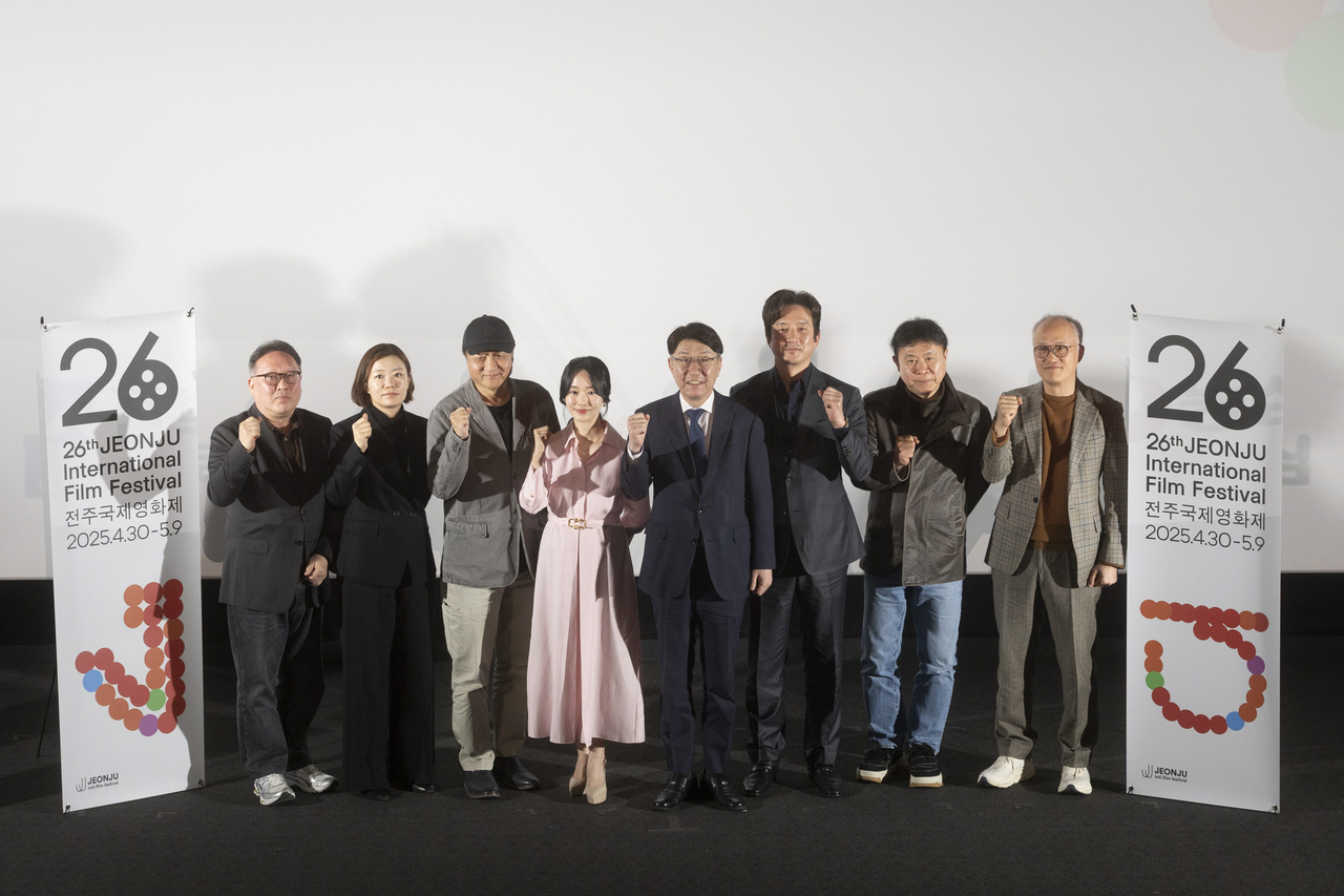From left: programmer Moon Seok, programmer Moon Sung-kyung, Executive Committee co-Director Min Sung-wook, actor Lee Jung-hyun, Organizing Committee Chair Woo Beom-ki, Executive Committee co-Director Jung Jun-ho, programmer Chun Jin-soo, and programmer Park Tae-joon pose during a press conference at CGV Yongsan in Seoul on Tuesday. (JIFF)