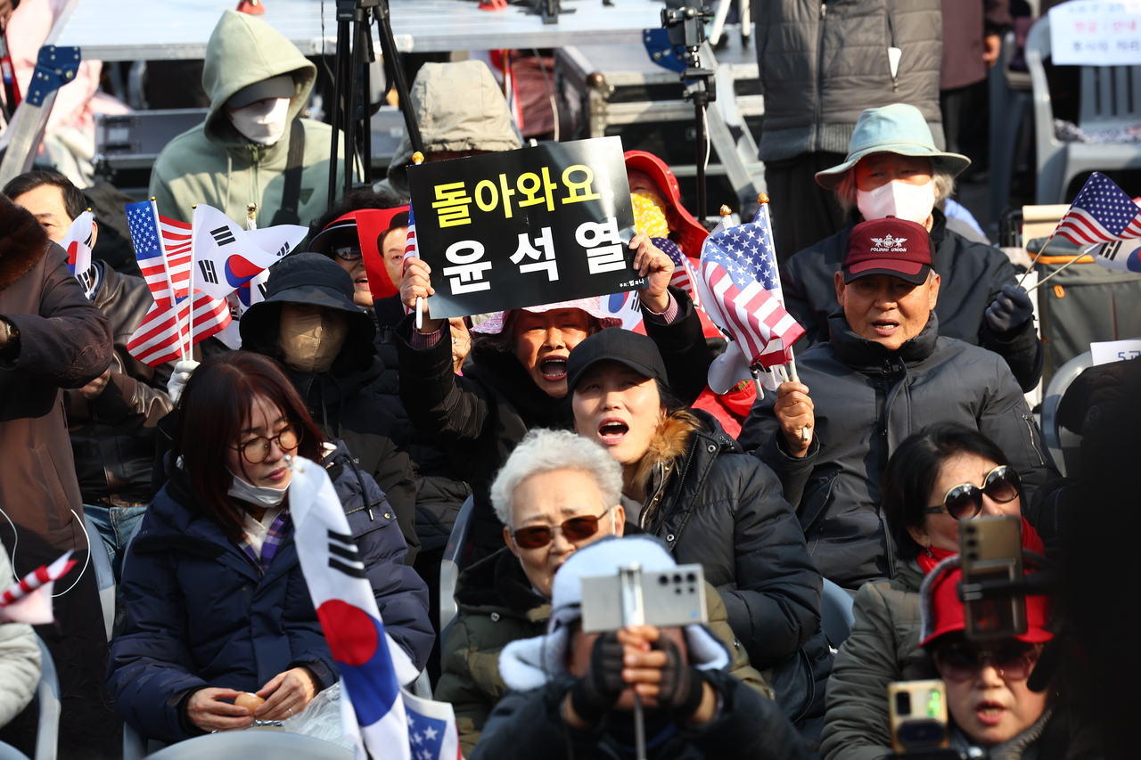 Protestors opposing Yoon Suk Yeol's impeachment hold a demonstration near the president's official residence in Hannam-dong, Yongsan-gu, Seoul, Friday.