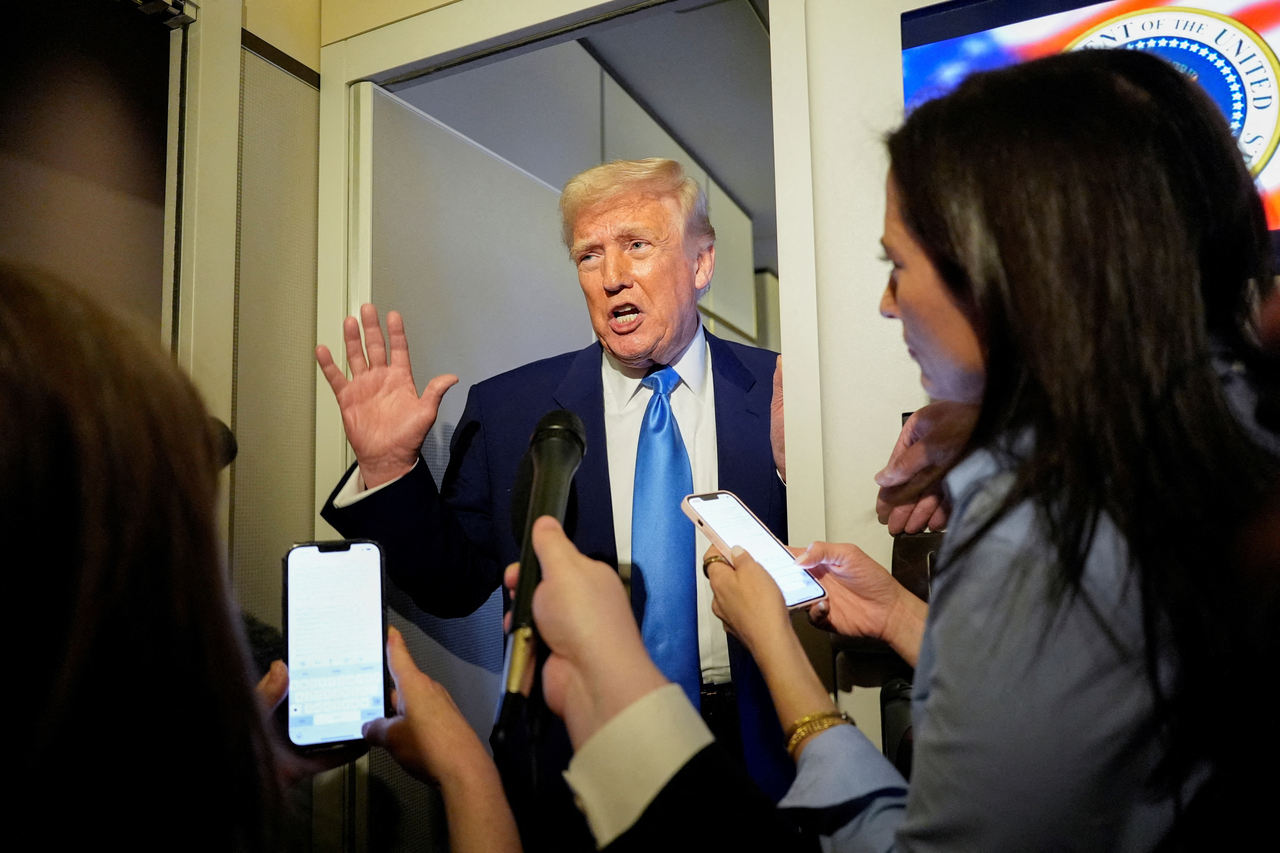 US President Donald Trump talks to members of the press aboard Air Force One during a flight to Joint Base Andrews, Maryland, US, April 6, 2025. (Reuters-Yonhap)