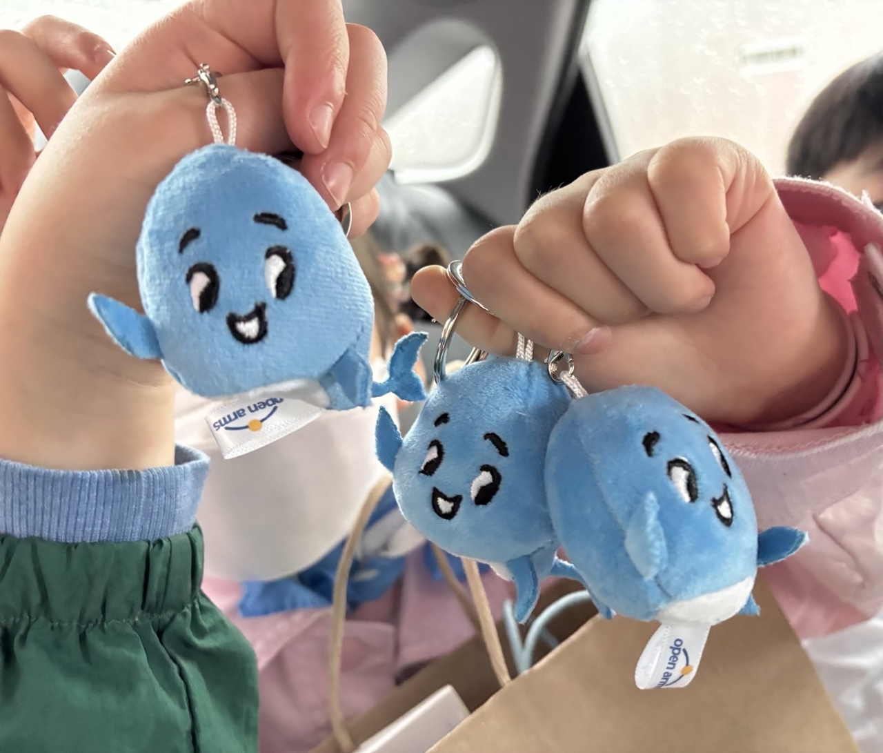 Children show their stuffed "Haneul" keyrings depicting the whale character created by Disney animator Kim Jin and the children themselves. (Open Arms)