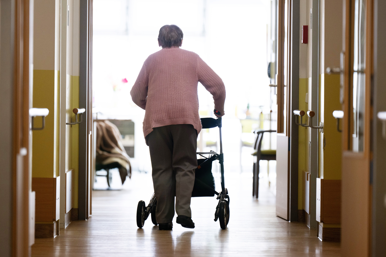 A woman walks along a corridor with a rollator in a retirement home. (GettyImages)