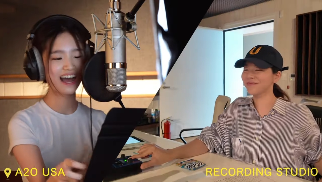 Sunny (right) directs a recording session with a young musician at a US studio in this screenshot from a video posted Monday on A2O Entertainment’s YouTube channel. (A2O Entertainment)