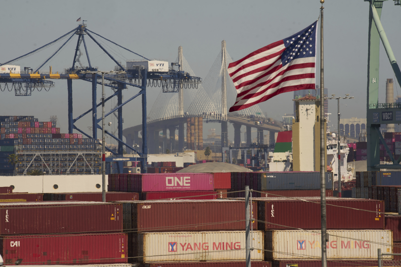 Containers are stacked up at the Port of Los Angeles with the the Long Beach International Gateway Bridge seen in the background on Wednesday.  AP-Yonhap