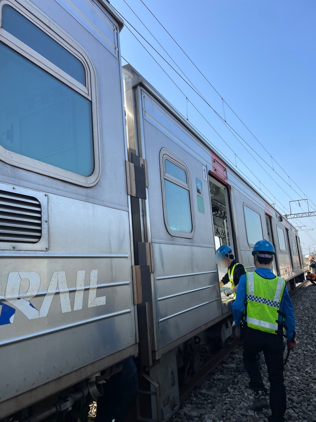 Officials inspect a train on the Gyeongui-Jungang Line after making an emergency stop in Paju, just north of Seoul, on April 11, 2025, in this photo provided by the fire authorities. (Yonhap)