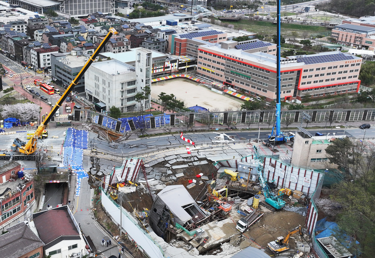This photo shows an aerial view of the damaged Yangji Intersection running above the collapsed subway tunnel construction site in Gwangmyeong, Gyeonggi Province, taken on Sunday. (Yonhap)