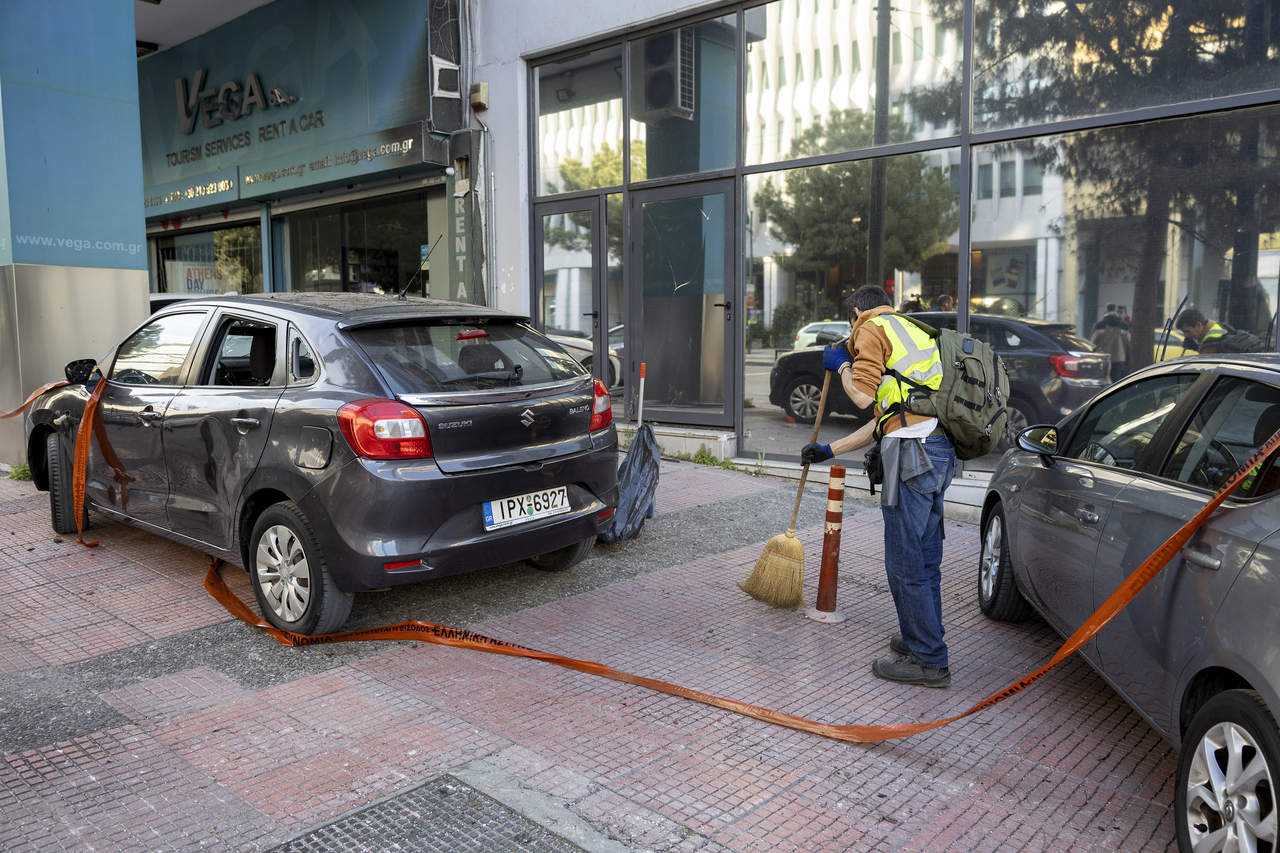 A municipal worker cleans the area outside Hellenic Train headquarters in Athens, Greece, Saturday. (AP-Yonhap)
