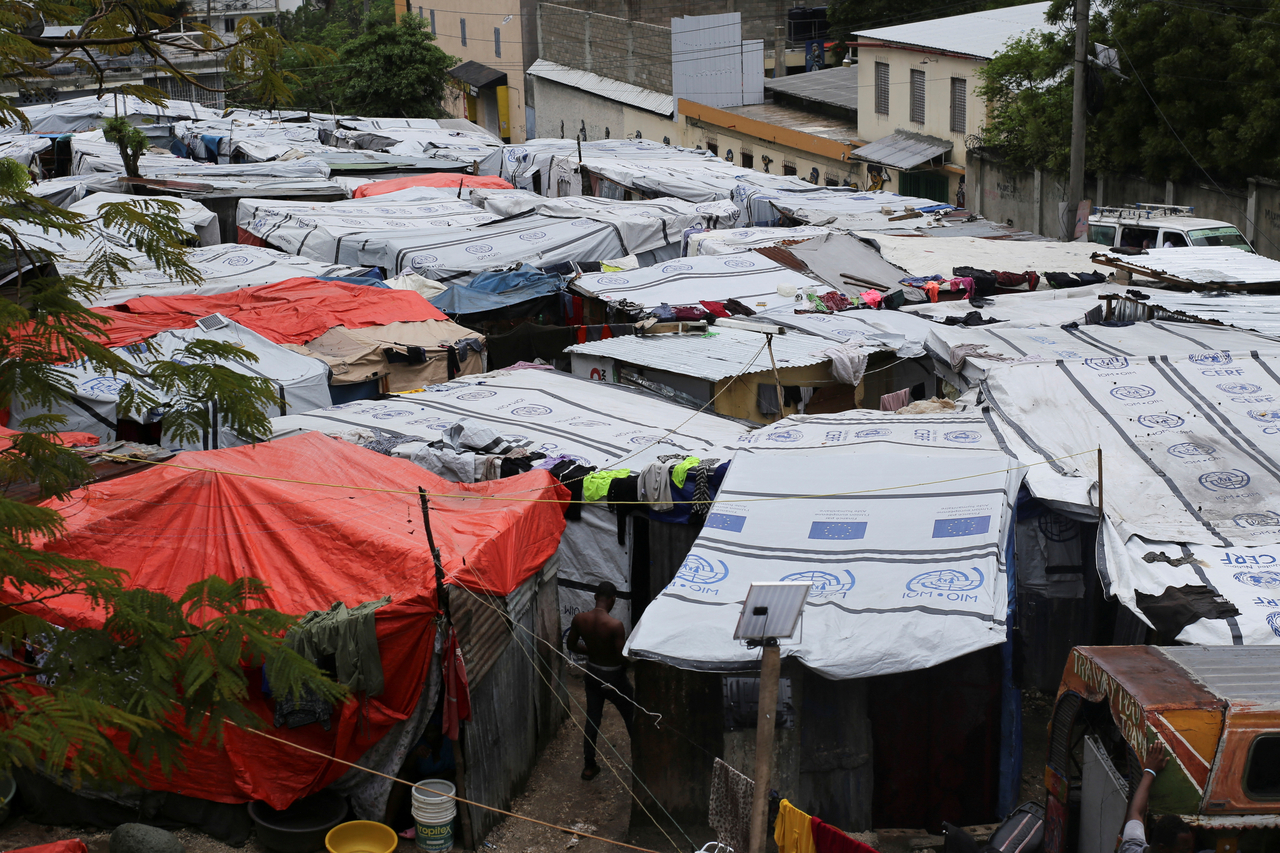 A man walks among shacks at the Fusion of Haitian Social Democrats party headquarters, which shelters people displaced by gang violence, in Port-au-Prince, Haiti, Sunday. (Reuters-Yonhap)