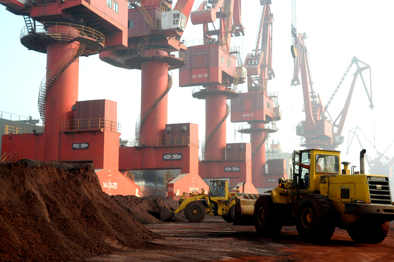 Workers transport soil containing rare earth elements for export at a port in Lianyungang, Jiangsu province, China, Oct. 31, 2010. Reuters-Yonhap