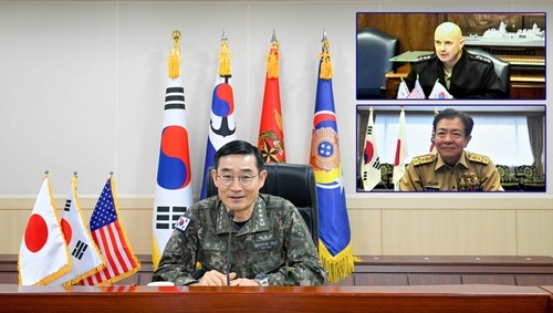 This composite photo provided on Thursday, shows the Korea's Chief of Naval Operations Adm. Yang Yong-mo (left) holding a teleconference with his US and Japanese counterparts, Adm. James Kilby (top right) and Adm. Akira Saito. (Korea Navy)