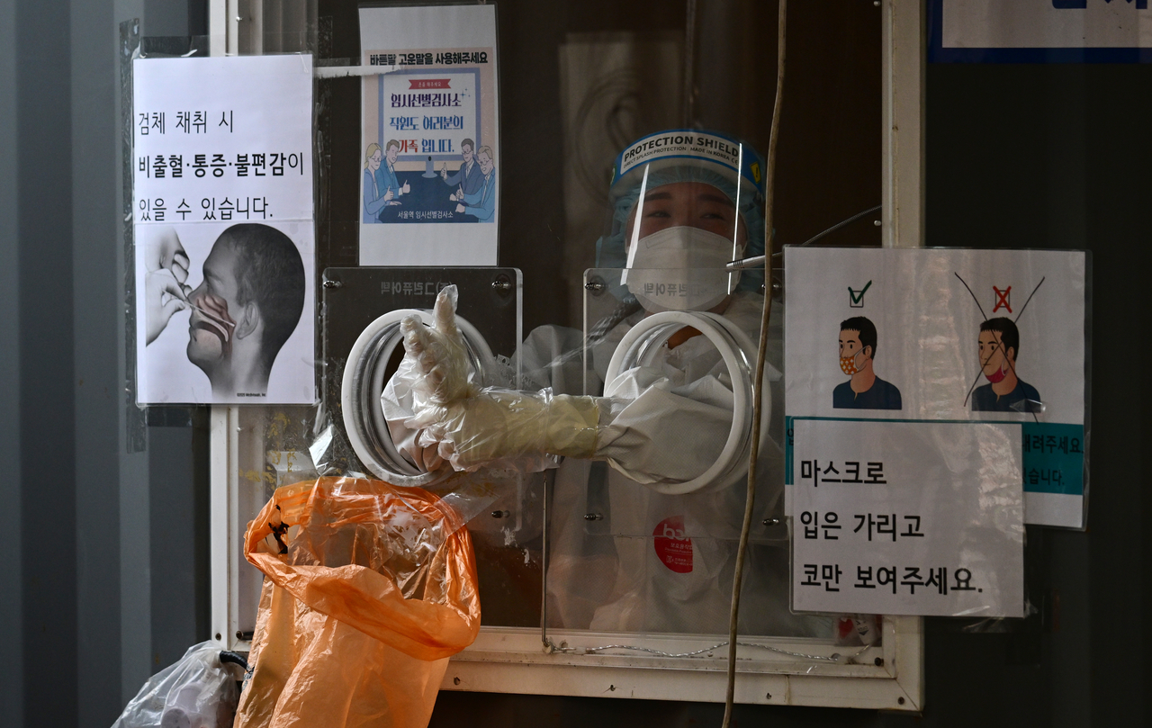 서울역 광장 임시선별검사소의 한 의료진이 PCR 검사를 하기 위해 시민을 기다리고 있다.  박해묵 기자