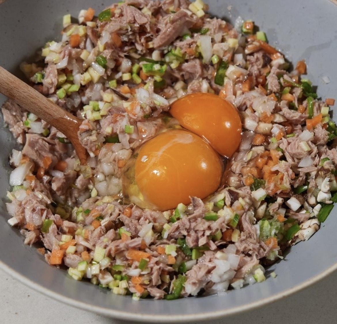 Tuna, chopped onions, carrots, green onion and eggs are mixed in a bowl to make "chamchijeon," or savory Korean tuna pancakes. (W Table)