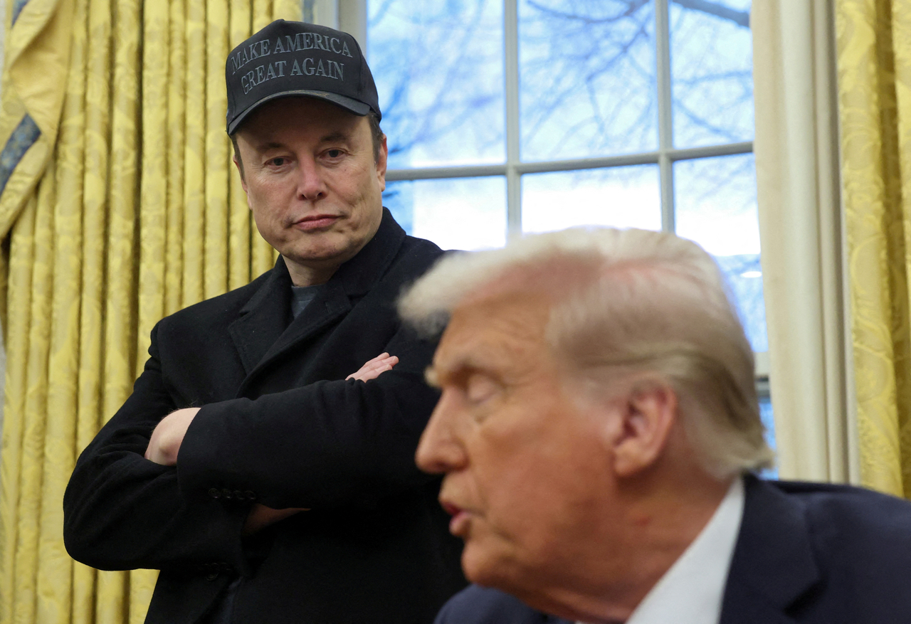 Elon Musk listens to US President Donald Trump speak in the Oval Office of the White House in Washington, in February. (Reuters-Yonhap)