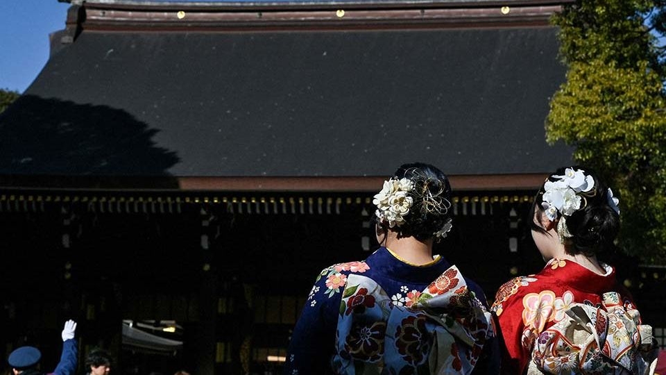 Young women wearing kimonos to mark “Coming-of-Age Day,” at Meiji Shrine in central Tokyo on Jan. 13. Japan News