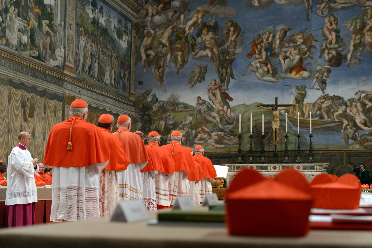 This handout picture released by the Press office shows cardinals queuing in the Sistine Chapel to swear on the Bible to never reveal the secrets of their deliberations before the start of the conclave at the Vatican on March 12, 2013. (Handout via AFP)
