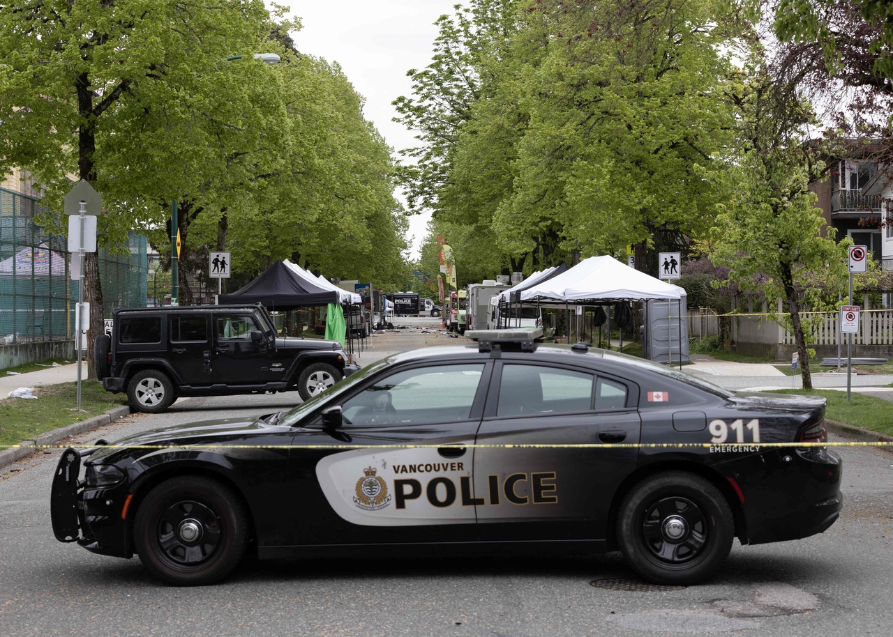 Police investigate the crime scene where a car drove into a crowd of people in Vancouver, Canada, Sunday. (AFP-Yonhap)